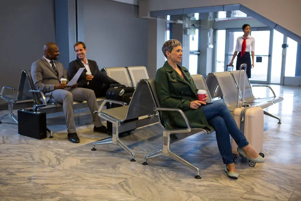 woman sitting with luggage waiting area 1024x683 1